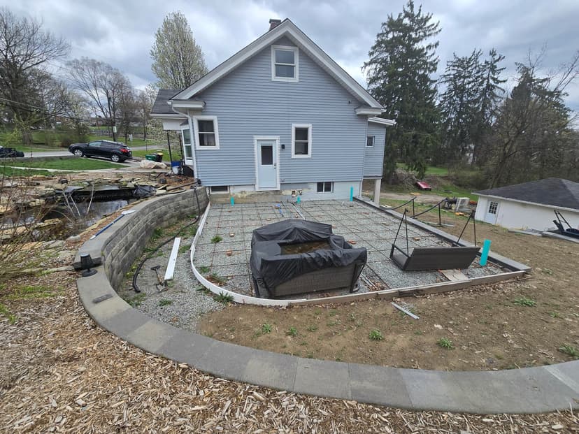 place and finish a 22x22 exposed aggregate concrete patio with a compass rose stamp (labor only)