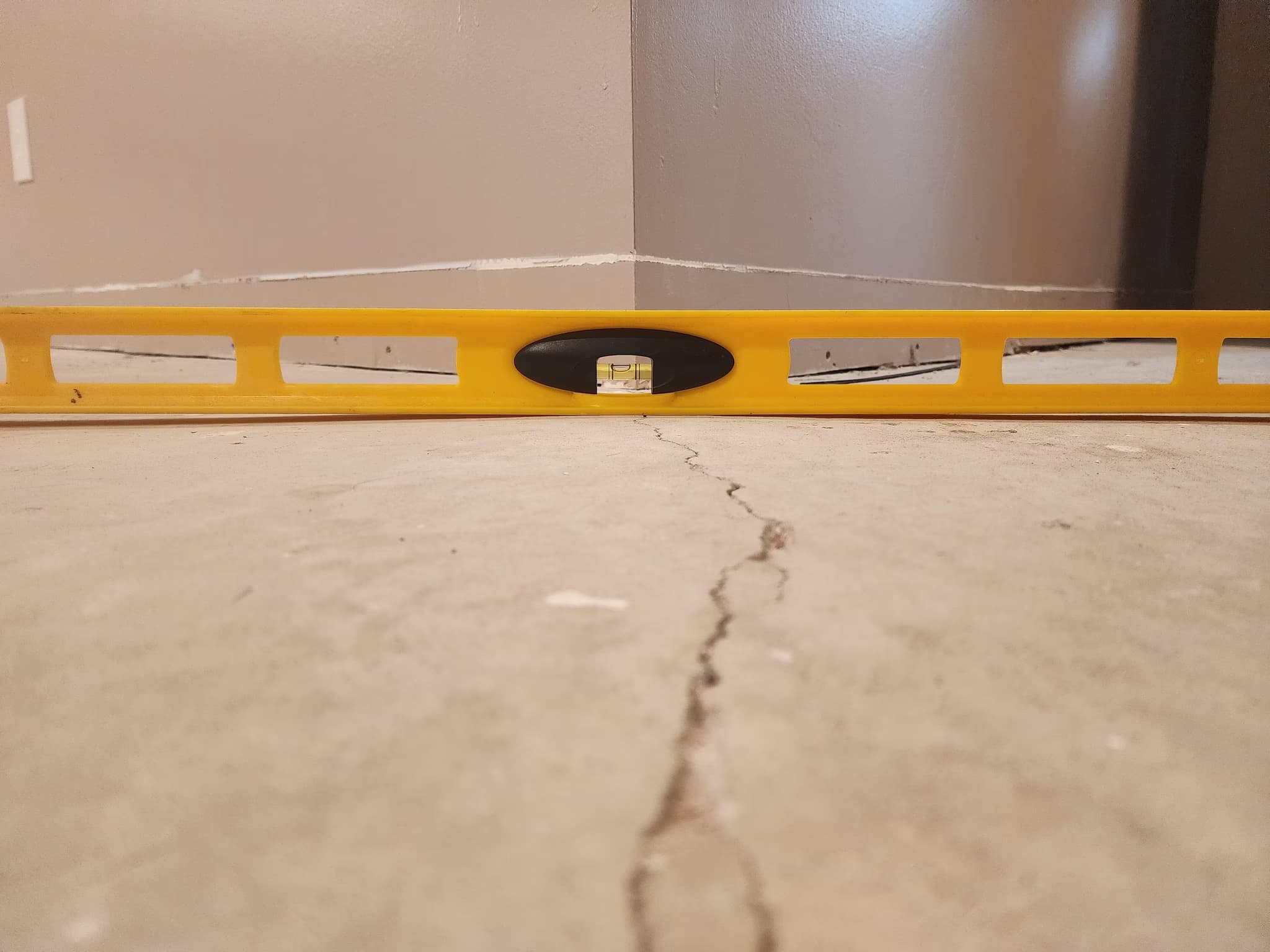 apply self leveling cement to a large basement kitchen floor
