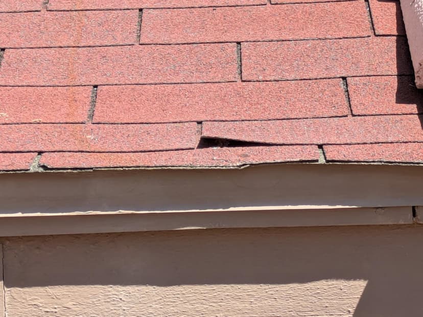 fix damaged asphalt shingles at roof edge