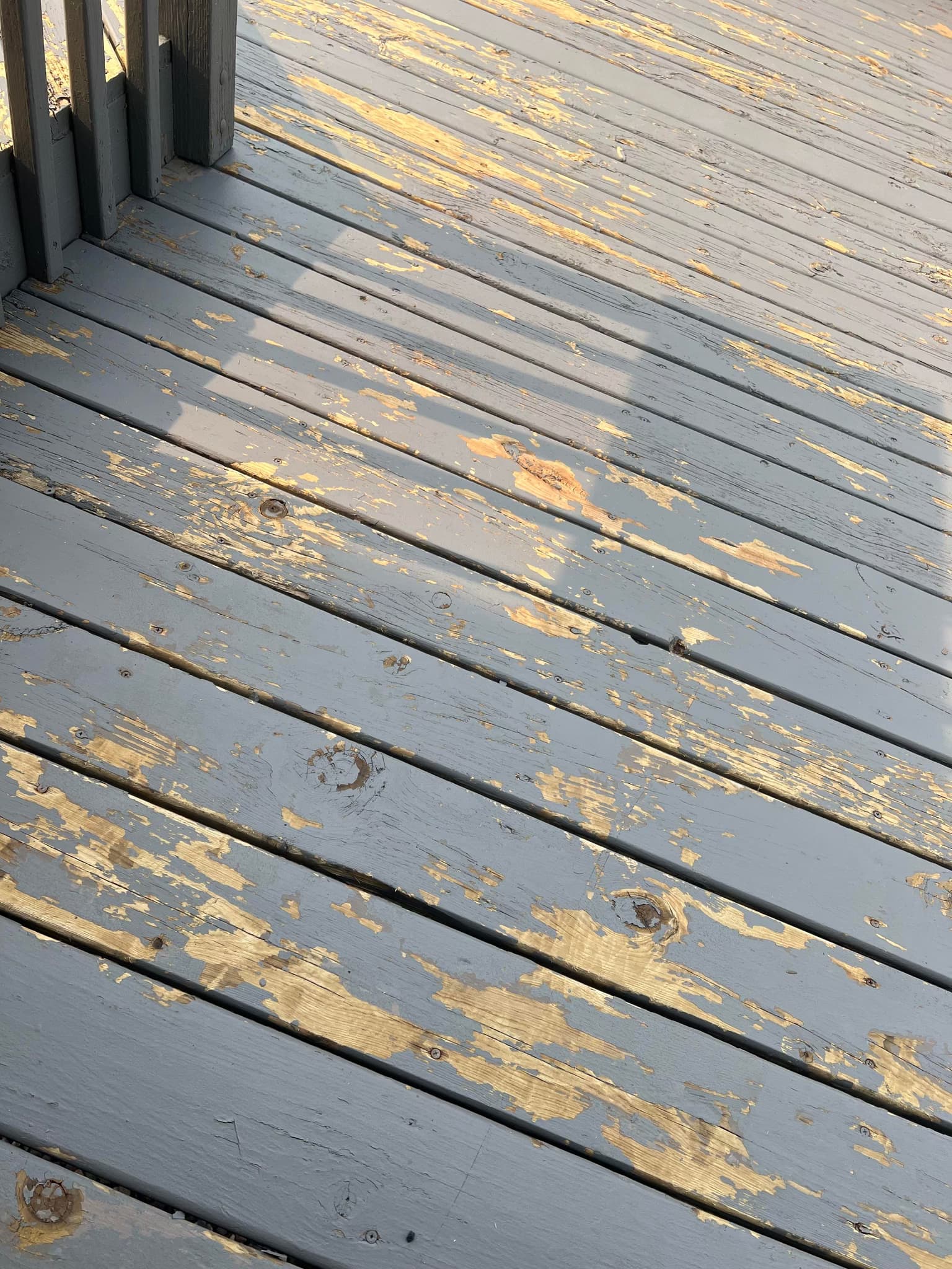 bring a paint scraper and belt sander to the hand railings and all of the floor deck boards and switch from staining to painting