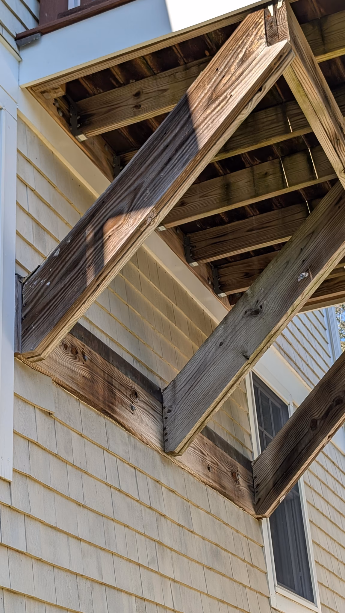 install 14-foot posts on footings and remove angled support for a deck