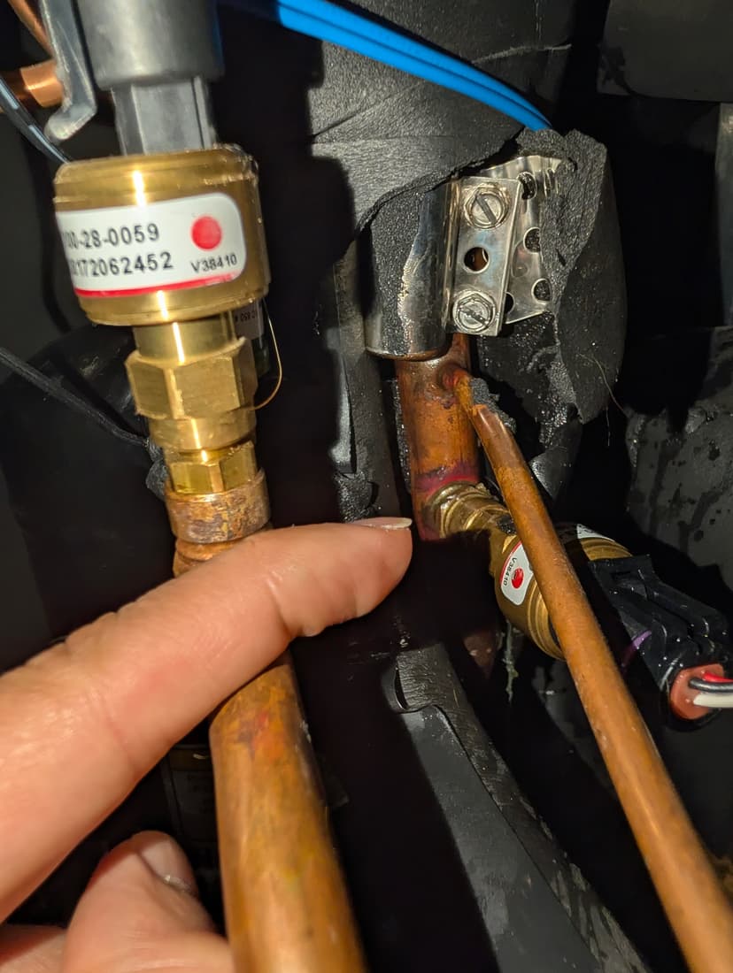 repair a refrigerant leak at the suction line service port
